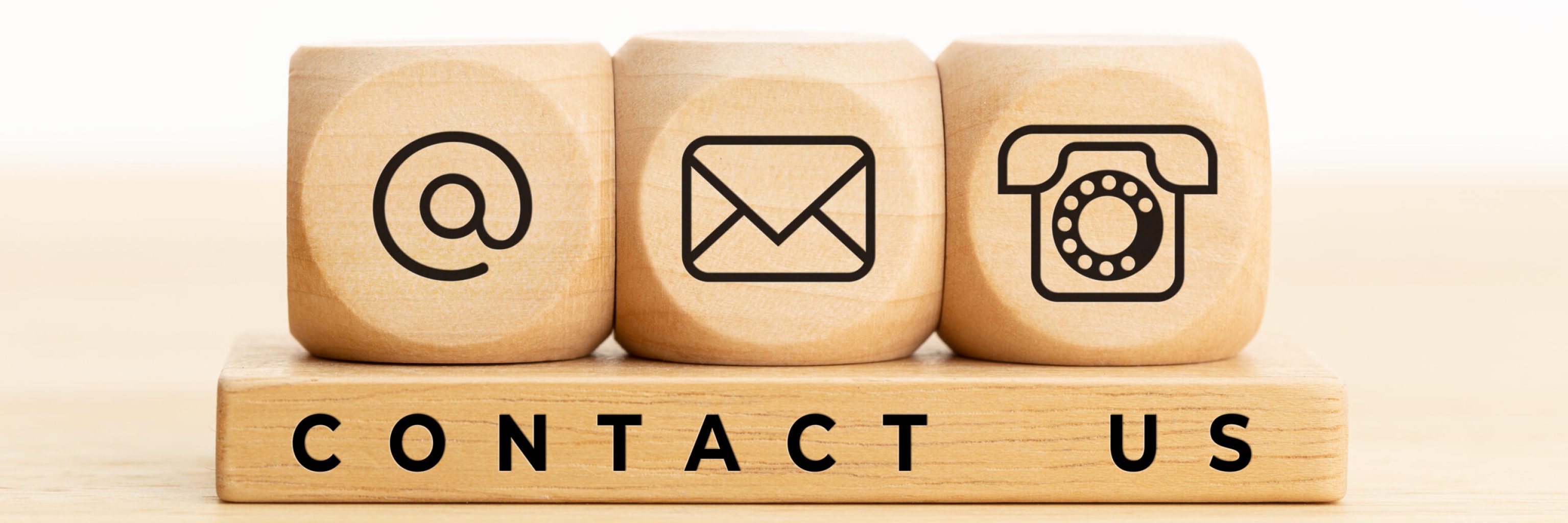 Contact us concept. Wooden blocks with email, mail and telephone icons.Website page contact us or e-mail marketing